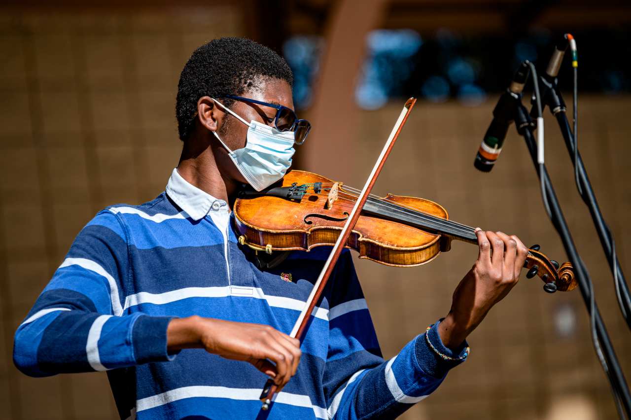 Suzuki Method Overview - young boy teenager performing violin wearing mask